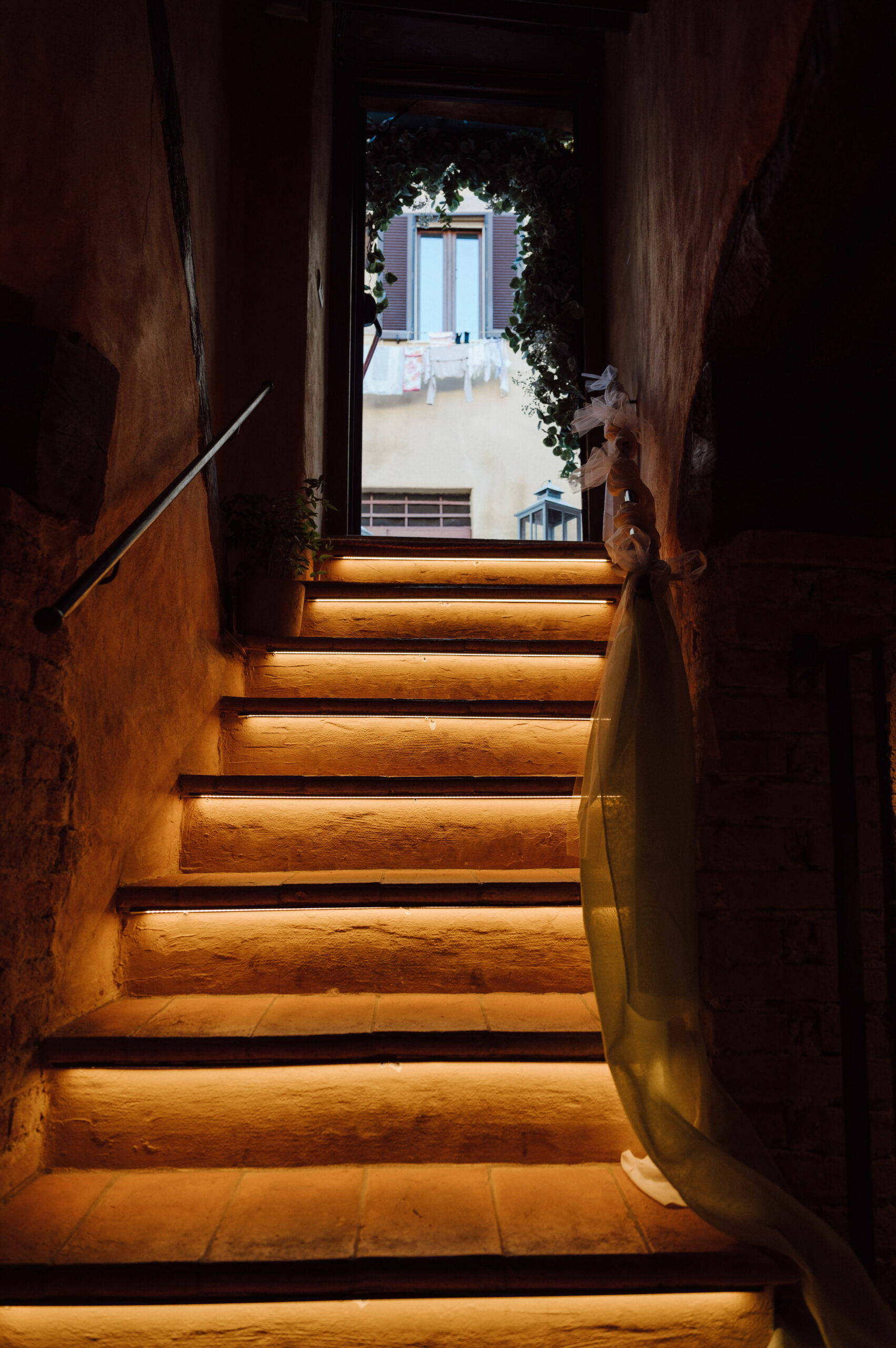 Warmly lit tuff-stone staircase